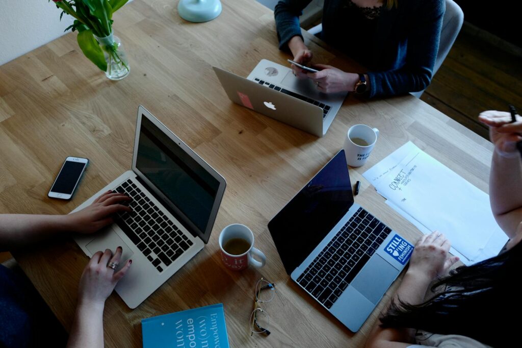 two person using macbook pro