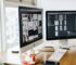 silver imac on top of brown wooden table